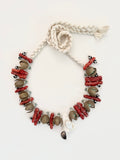 Fragments of the Sea ... from Mediterranean travels and curated finds. One-of-a-kind handcrafted necklace assembling coral branches, oxidized metal, semi-precious stones, and a pumice centerpiece set with mother of pearl. Adjustable braided cotton threads holds together this timeless piece handmade in Lebanon with worldwide sourced materials. Objects that outlive trends.