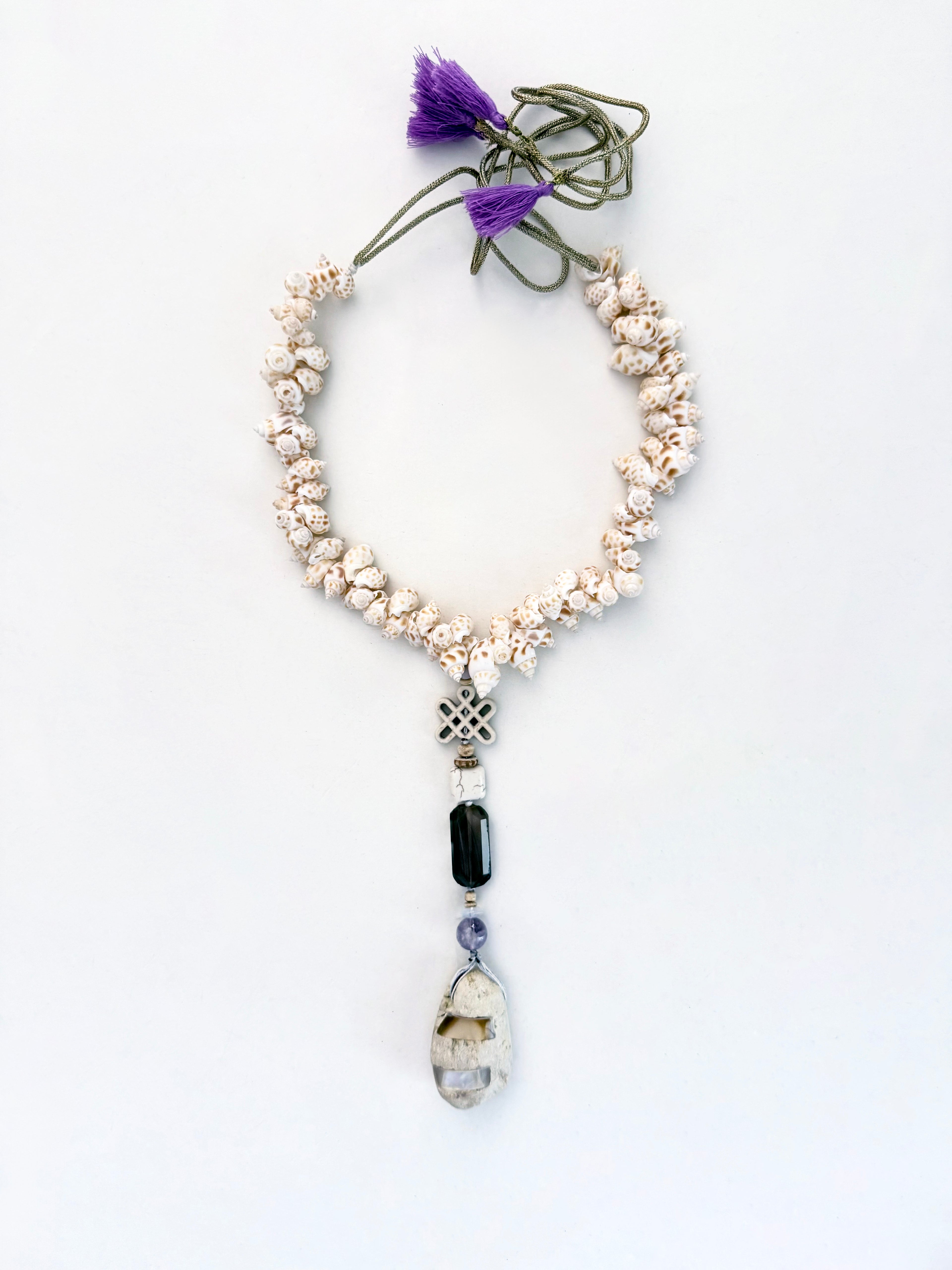 MAREA Collected by the sea. Worn with intention.

Pièce unique — handmade with natural sea shells, howlite, agate, and amethyst stones &nbsp;and a pumice pendant inlaid with mother of pearl.

Nature's architecture. Human hands.