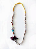A gathering of sea, thread and time.
Pièce unique handmade in Lebanon with braided yellow cotton threads, natural shells, coral, ocean jasper and turquoise stones and an antique Ottoman tassel.
A wearable relic for sea nomads.
